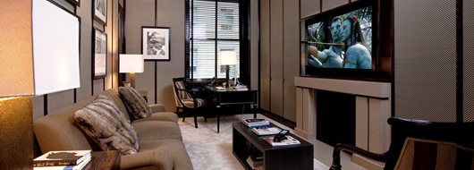 Luxury home theater lounge with custom plush seating, optimized viewing angles, and acoustic paneling for superior film and sports entertainment