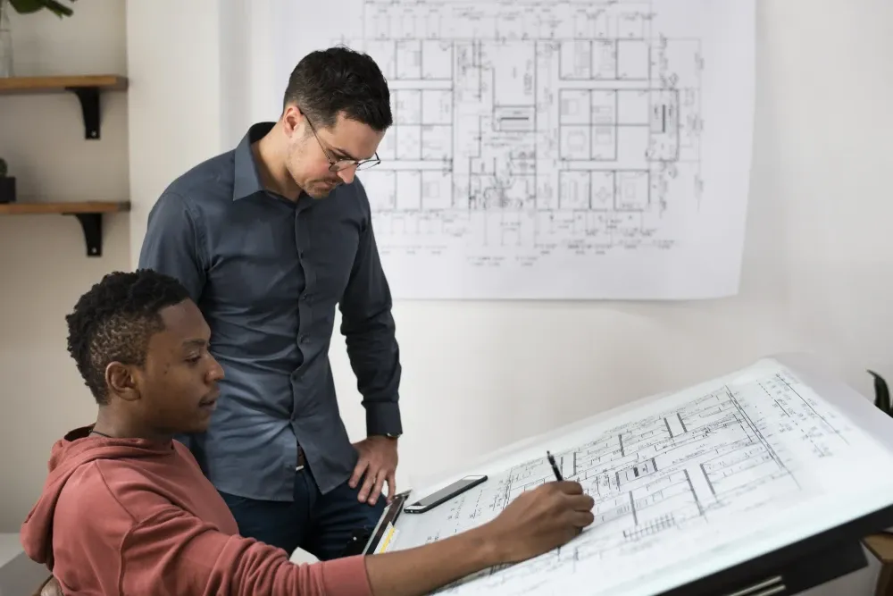 Deer Valley smart home system design consultation with homeowner and architect reviewing custom automation blueprints