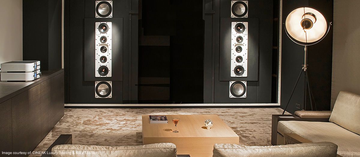 Custom Park City home theater with integrated wall-mounted touchscreen for Control4/Savant automation, enabling effortless control of lighting, climate, audio, and video